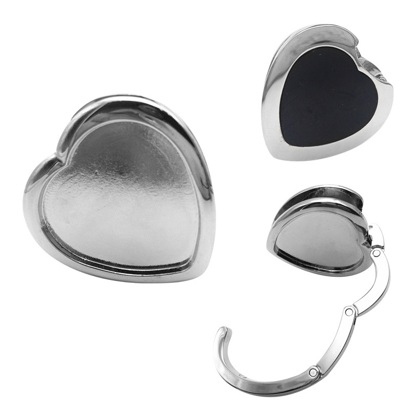 Unique Design The heart shape design adds a touch of elegance and charm to your handbag hanger,making it a stylish and eye-catching accessory that will surely turn heads.It can be easily matched with handbags or wallets, adding highlights to your overall look.The elegant curves and intricate details of the heart shape make this purse hook a statement piece that will complement any handbag or outfit. Show off your love for fashion with our Heart Shape Handbag Hanger Purse Hook.